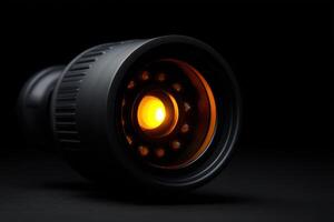 Night vision CCTV lens emits orange glow in low light setting for surveillance purposes photo