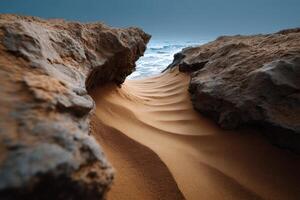 Waves of sand creating patterns in a rocky coastal inlet during twilight photo