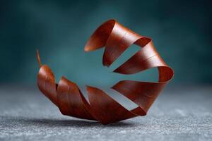 Coiled copper wire curls gracefully against a textured background photo