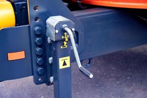 Close-up of a mechanical crank handle on a trailer jack stand. photo
