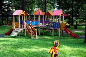 Colorful children's playground in a green park. Community children. photo