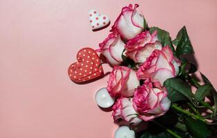 Day background with blank paper card mockup, gifts, red hearts, confetti on pink. photo