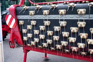 Agricultural machinery close-up with metal components and red frame. photo