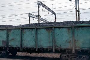 Freight train wagon loaded with coal at a railway station. photo