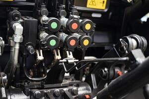 Close-up of hydraulic control system with colored connectors. photo
