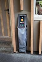 Control panel with buttons on the wall, covered with a protective cover. photo