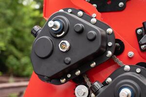 Close-up of red agricultural machinery with measuring scale. photo