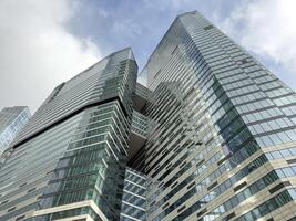 Glass skyscrapers with reflective surfaces reaching into the sky, symbolizing innovation, growth and the dynamic nature of contemporary urban architecture and business hubs photo