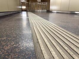 Tactile paving for visually impaired pedestrians installed in a public transport facility, highlighting modern inclusive infrastructure and urban accessibility in contemporary city design photo