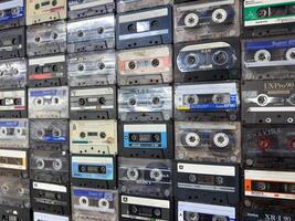 Moscow, Russia, April 27, 2025 Horizontal retro background with tightly packed vintage cassette tapes, perfect for nostalgic layouts, creative designs or music related visual textures photo