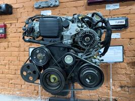 Moscow, Russia, April 27, 2025 Japanese car engine on display, showcasing serpentine belt system with multiple pulleys and tensioners, mechanical complexity and automotive engineering design photo