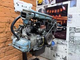 Moscow, Russia, April 27, 2025 Aged Japanese car engine on display with weathered paint, visible rust, and vintage details, evoking nostalgia and showcasing the patina of automotive history photo