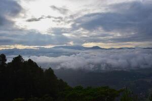 A view of the mountains and clouds from a hilltop photo