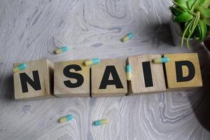 Concept of NSAID Symbol. Wooden block with words NSAID photo
