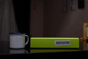 folders with the label Investigations, Business management concept photo