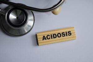 Concept of Acidosis Symbol. Wooden block with words Acidosis. stethoscope and pharmaceuticals photo