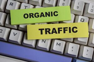 Concept of Organic traffic write on sticky notes isolated on keyboard. photo