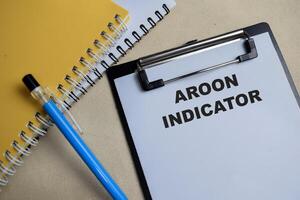 Concept of Aroon indicator write on clipboard isolated on Wooden Table. photo