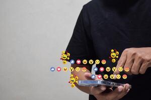 man hand hold smartphone and use social media network application to check new feedback or interactive with people photo