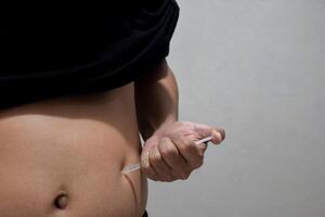 man injecting himself with obesity medication photo