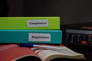 folders with the label Compliance and Regulations. Business management concept photo