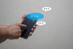 man hand using smartphone typing, chatting conversation working home in chat box pop up. social media marketing technology concept photo