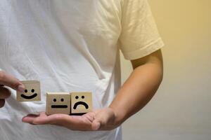 smile face and cart icon on wooden cube, optimistic person or people feeling inside, satisfaction concept in business photo