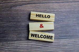 Concept of Hello and welcome Symbol. Wooden block with words Hello and welcome photo