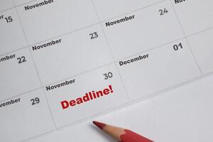 Focus on number 30 in calendar and Dealine text. Save the date. Day of the year concept. photo