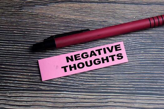 Concept of Negative thoughts write on sticky notes isolated on Wooden Table. photo