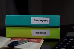 folders with the label Employees and Salaries. Business management concept photo