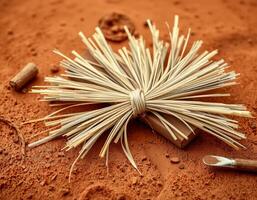 Harmonious straw bunch tied on small box with natural brown background and brush photo