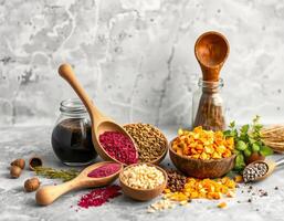 Dried herbs and spices in wooden bowls and spoons with natural ingredients on table photo