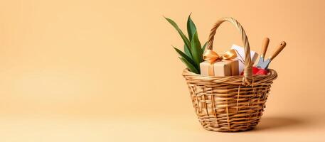 Gift basket with green leaves and gardening tools on beige background photo