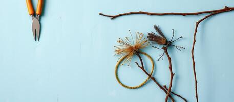 Dried flowers and twigs with garden shears on blue background create calm natural scene photo