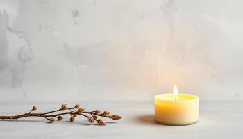 Minimalist candlelight with dried branch on marble surface creating calm and warm mood photo