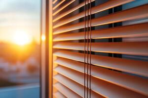 Sunlight shining through window blinds at sunset creating cozy atmosphere photo