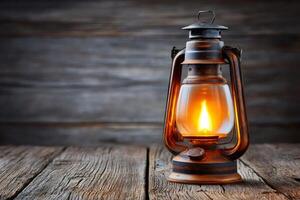 Burning oil lamp illuminating rustic wooden table in moody setting photo