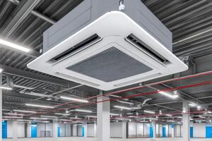 Modern air conditioner hanging from ceiling in empty office space photo