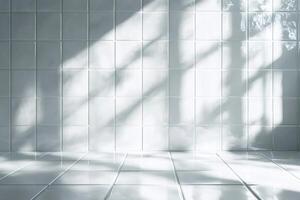 Empty room with white tiles and window shadow reflecting on floor photo