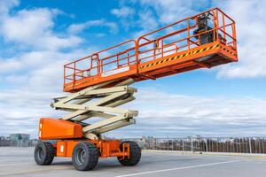 Scissor lift parked on rooftop under cloudy sky awaiting operation photo