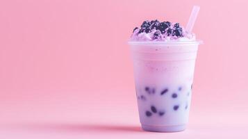 Bubble tea with blackberries and milk on a pink background photo