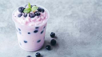 A pink drink with blueberries and mint photo