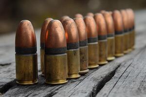 Ammunition Row on Weathered Wood Surface Bullet Display for Military and Law Enforcement Themes photo
