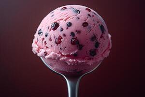 Delicious Berry Ice Cream Scoop on a Spoon Against Dark Background photo