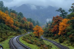 Autumn Railway Journey through Foggy Mountain Landscape for Scenic Travel and Nature Exploration photo