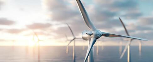 The wind turbine standing tall against a beautiful sunset over the ocean. photo