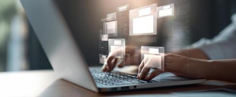 The laptop displaying digital interfaces with hands typing on the keyboard. photo