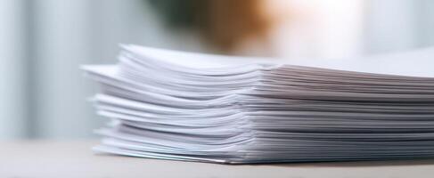 The stacked sheets of white paper on a workspace desk background. photo