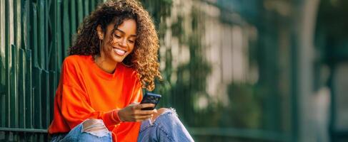 The young woman using her smartphone while enjoying a sunny day outdoors. photo